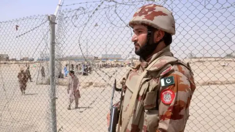 A Pakistani security official stands guard at the Pakistan Afghan border in Chaman, Balochistan province.