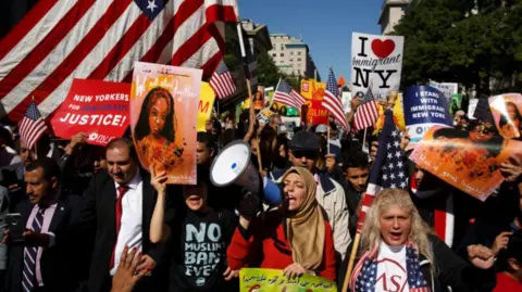 Getty Images A group of people march in the street in New York