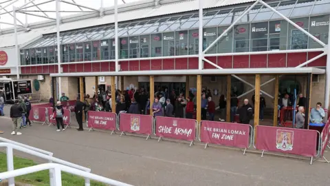 Northampton Town Football Club Fans gather at the Brian Lomax Fan Zone which is fixed to the rear of the West Stand at Sixfields Stadium.