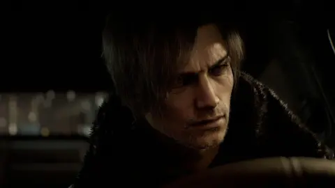 Capcom An in-game screenshot showing the character Leon S Kennedy from Resident Evil Requiem at the wheel of a car looking concerned.
