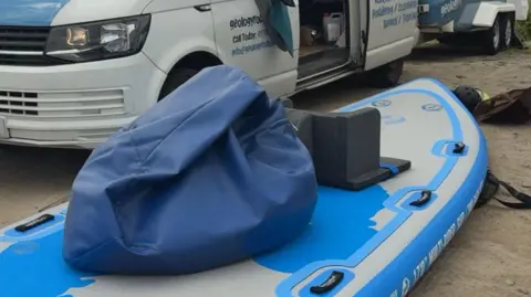 Large blue paddlebeboard with blue beanbag