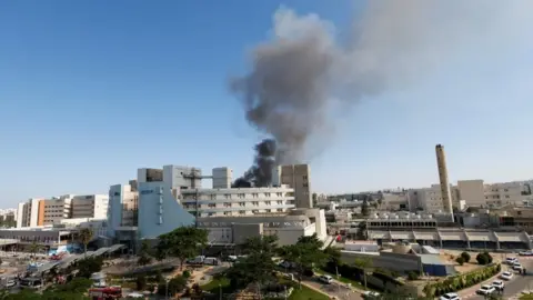 Smoke billows over the Soroka Medical Center following an Iranian strike