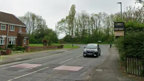 Google A residential street in Redcar, with two red-coloured speed bumps visible on the road.