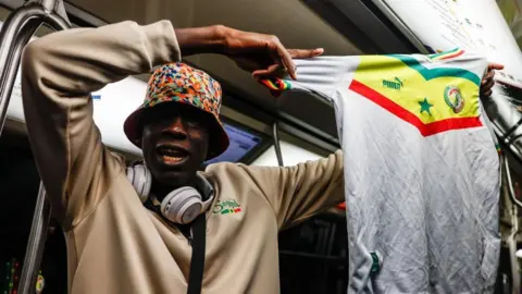 EPA A Senegalese fan holds his national team's jersey inside the Paris Metro after Senegal's victory over Morocco in the African Cup
