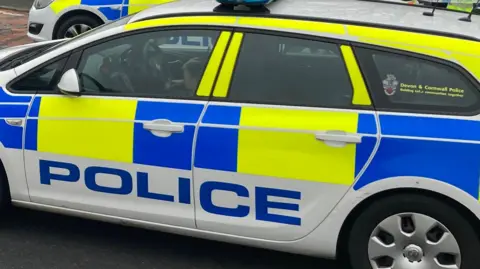 Two police cars parked next to each other. 