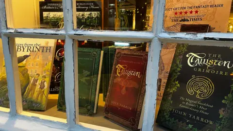 Supplied A collection of John Tarrow's books visible through a shop window