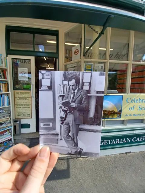 Henry Fothergill / Dave Mitchell Archive photo of customer standing outside shop