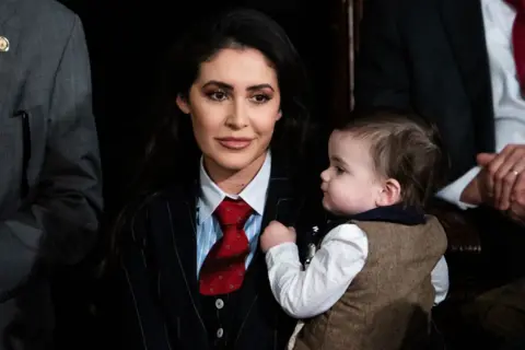 Getty Images Woman holds baby