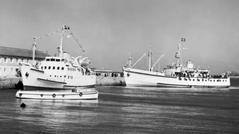 Isles of Scilly Steamship Group Twp ships by the pier in Penzance Harbour in 1977 , both of them are white 