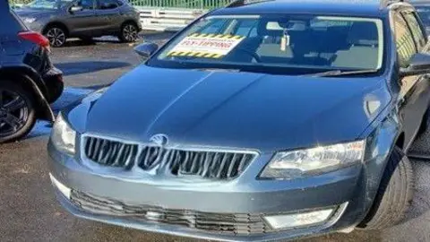 Bradford Council A blue car with a white, black and yellow notice attached to the left of its main window with the word fly-tipping written on it in red