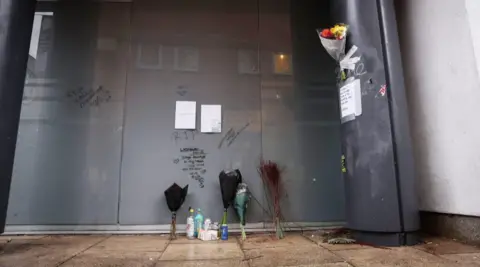 Flowers were left on the Manchester doorstep and RIP messages were scrawled on the wall at the spot where Vladislav Kavour, known to friends as Diego, was found dead after a fatal drug overdose. 