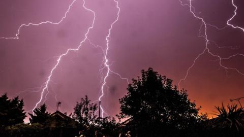 Lightning in the sky over buildings
