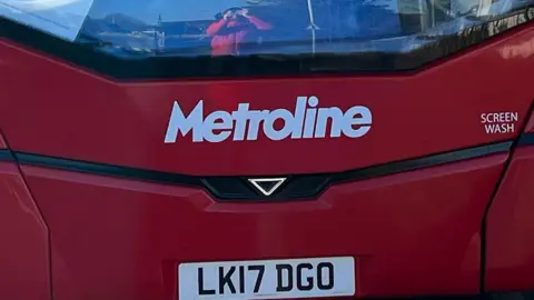 BBC/Harry Low Metroline bus front with number plate and screen wash sign
