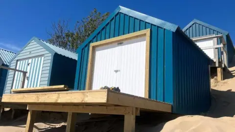 Beresford Adams Blue beach hunt with white double door entrance and balcony