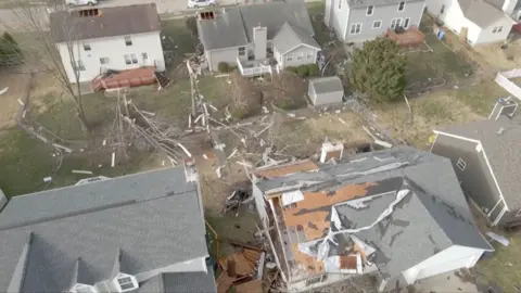 Aerial shot of houses with damaged roofs