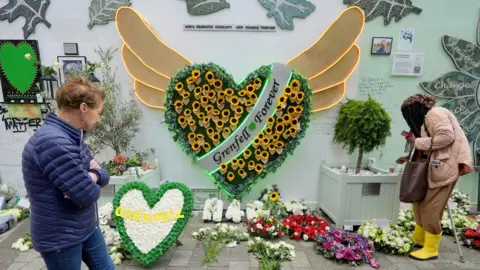 PA Media The memorial at the base of Grenfell Tower