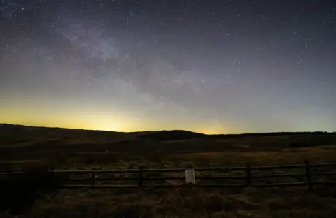 Serydda/Dafydd Wyn Morgan The Milky Way shines above a field and wooden fence