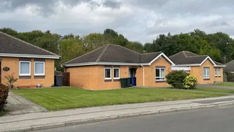 BBC/Simon Thake Bungalows with neatly mowed lawns