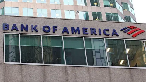 A close up shot of the sign on a Bank of America building