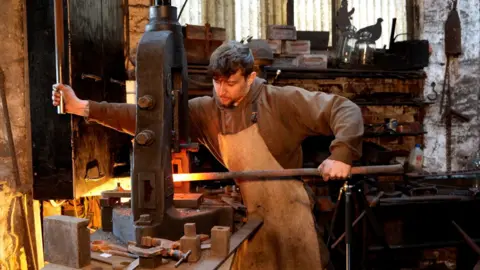 Jay Cardall at work as a blacksmith