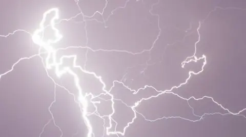 Bright lightning strike cuts through dark skies