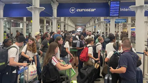 A wide shot of passengers queuing to at a Eurostar terminal.