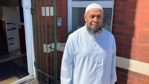 Imam Ibrahim Hussein outside Southport Mosque