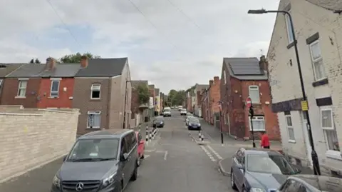 Hinde Street in Page Hall. A tightly packed terrace street with cars parked on either side of the road.