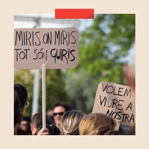 Getty Images A sign that says: "Miris on miris tot son guiris". In English this means "Everywhere you look everyone is foreign"