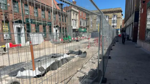 Connolly's Irish Pub is located behind major roadworks and high metal fencing.