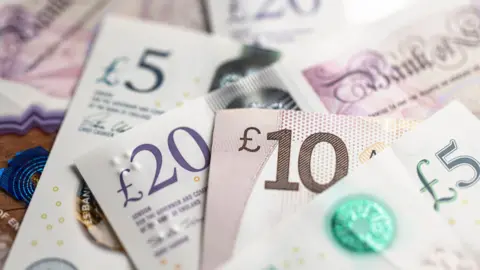 Getty Images Selection of banknotes including £5, £10 and £20 notes.
