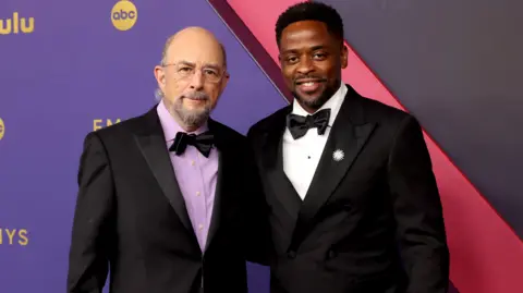 Getty Images Richard Schiff and Dulé Hill attend the 76th Primetime Emmy Awards at Peacock Theatre on September 15, 2024 in Los Angeles, California