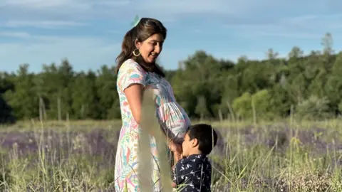 Handout A pregnant woman with her young son in a lavender field