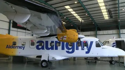 A Dornier propeller plane with the words Alderney and Aurigny on the side