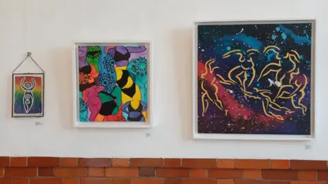 Nicola Davis Three artworks, in ascending size from left to right on a plain white backgroud, each with the human body in varying numbers, sizes and colours
