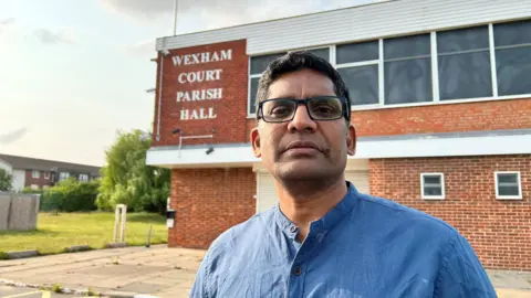 Chandra Kondepudi is wearing a blue top and is behind the building they want to purchase.