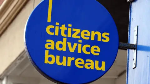A round Citizens Advice Bureau sign. It is blue with yellow text.