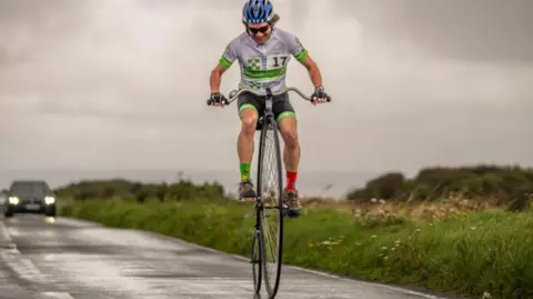 Visit Eastbourne  penny farthing rider in race