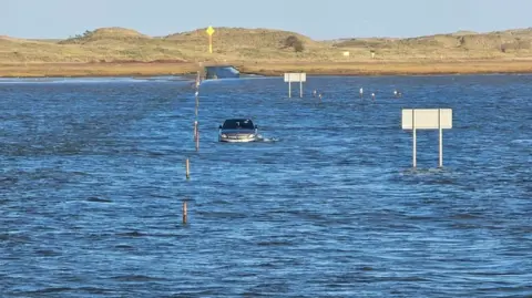 Dita Sanchez The Holy Island causeway is completely covered by the sea, and the Mercedes is submerged to a depth of about 2 feet.