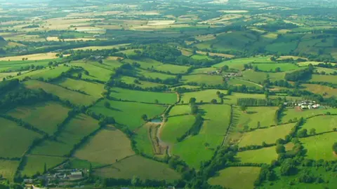 BBC Aerial view of green countryside