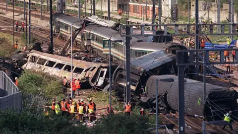 Emergency crews are on site at the wreckage of two trains which collided at Ladbroke Grove junction in 1999