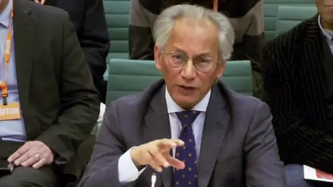 UK Parliament via AP Samir Shah gestures as he speaks while looking towards the camera in the UK Parliament hearing on 24 November.