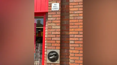 Emma Morgan/LDRS A cast of football boot beneath a No Ball Games sign