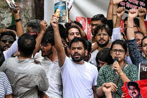 Bloomberg via Getty Images Abhijeet Dipke, founder of the "Cockroach Janta Party", center, speaks during a protest in New Delhi, India, on Saturday, June 6, 2026. 