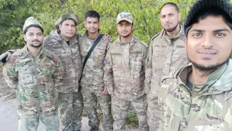 BBC A group of released men near the Russian-Ukrainian border on their way out