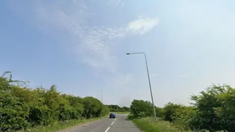 Google Blue sky above road with hedges to the side