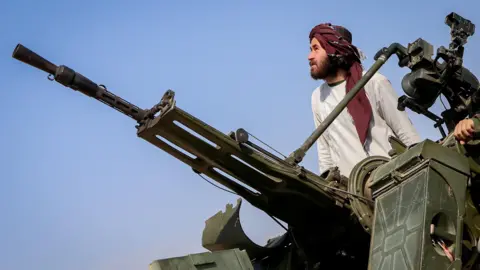 Reuters A Taliban soldier stands next to an anti-aircraft gun while on lookout for Pakistani fighter jets, in Khost province, Afghanistan, February 27, 2026.