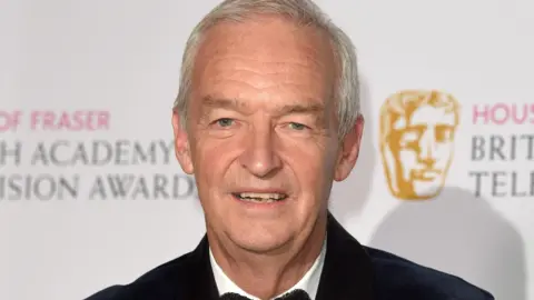 Jon Snow in a black jacket and bow tie at the Bafta Awards