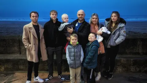 Family photo Wayne, his wife and children 