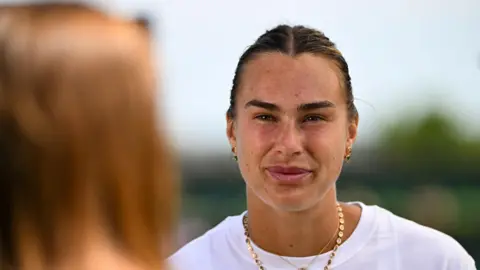 Aryna Sabalenka talks to the media